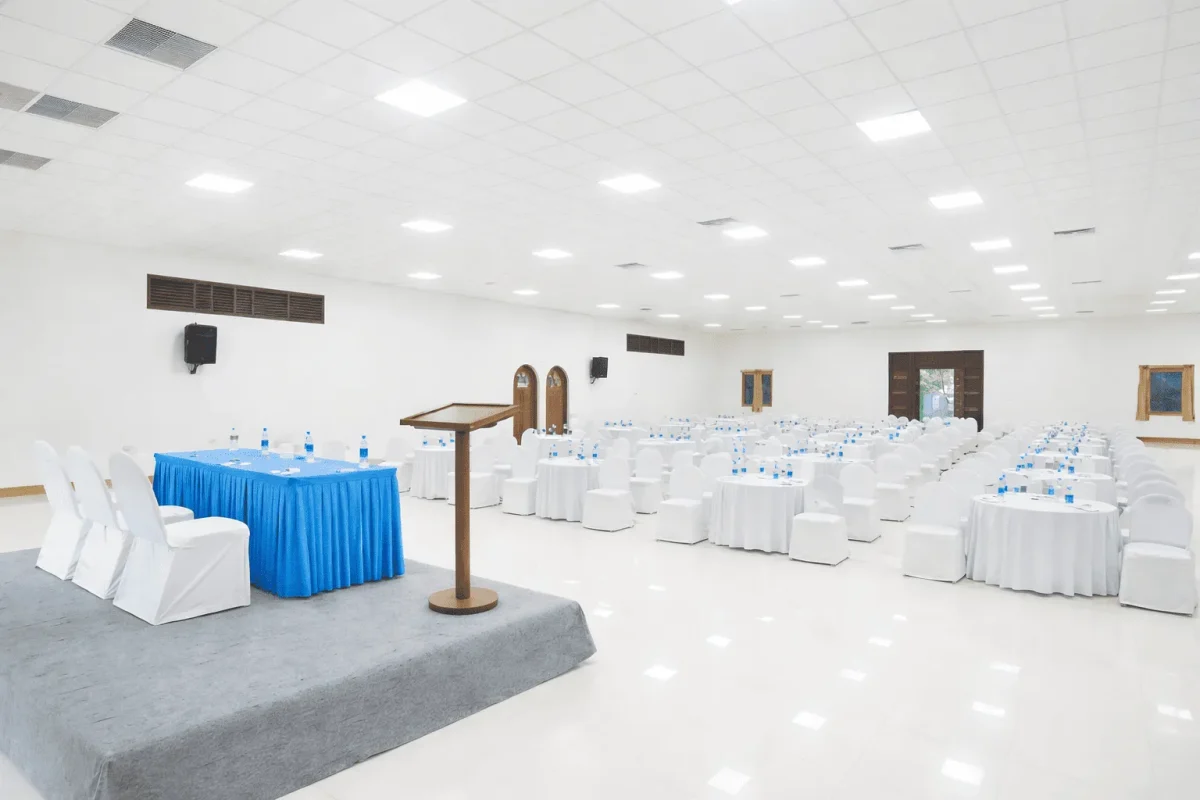 Conference hall in Madurai with a podium, classroom-style seating, modern lighting, and professional setup for corporate meetings and seminars.